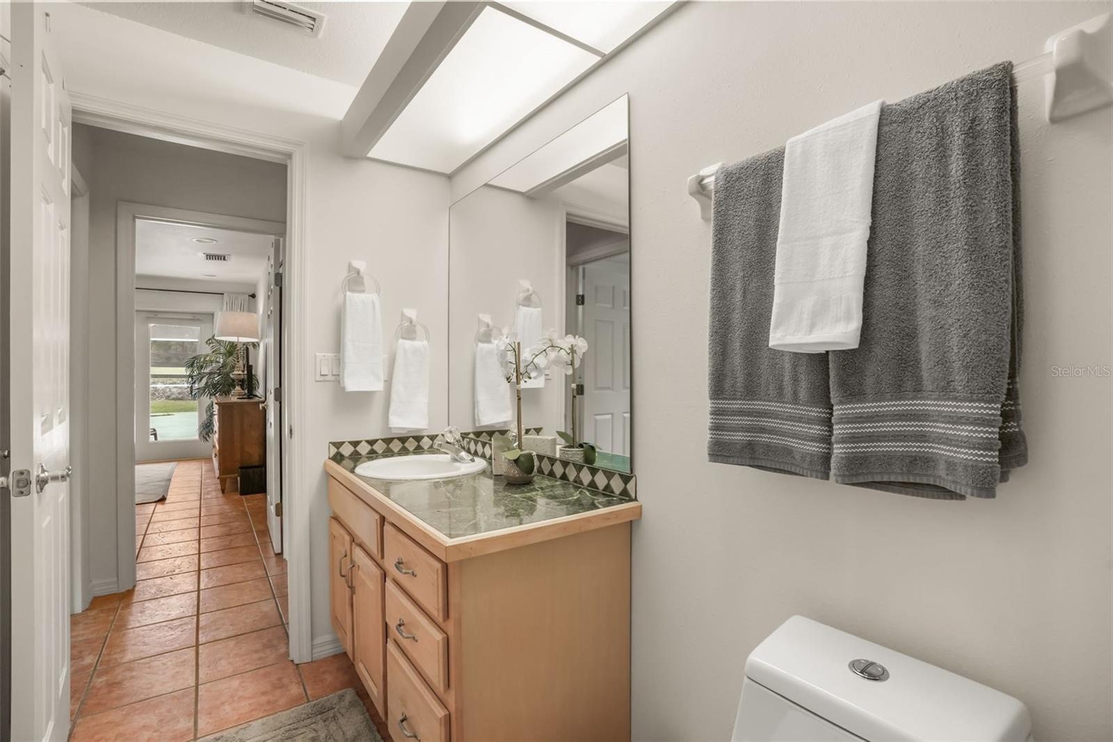 Guest bathroom featuring a spacious vanity and walk-in shower