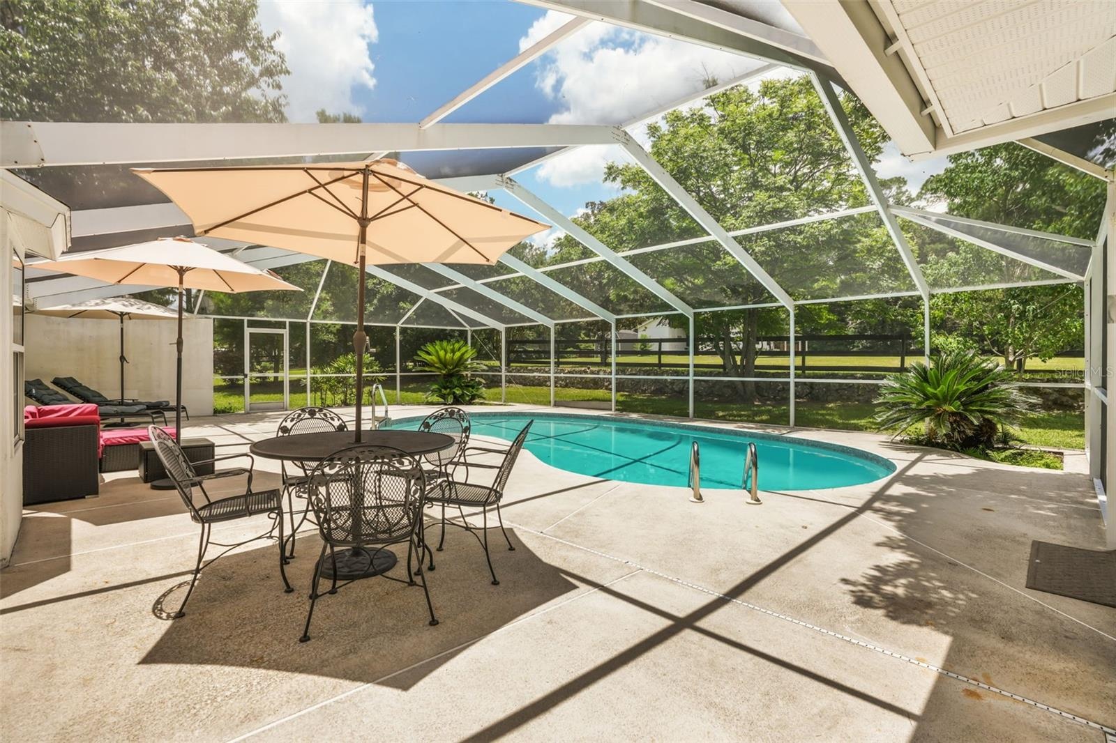 Screened pool area offering the perfect place to relax or entertain while enjoying peaceful farm views