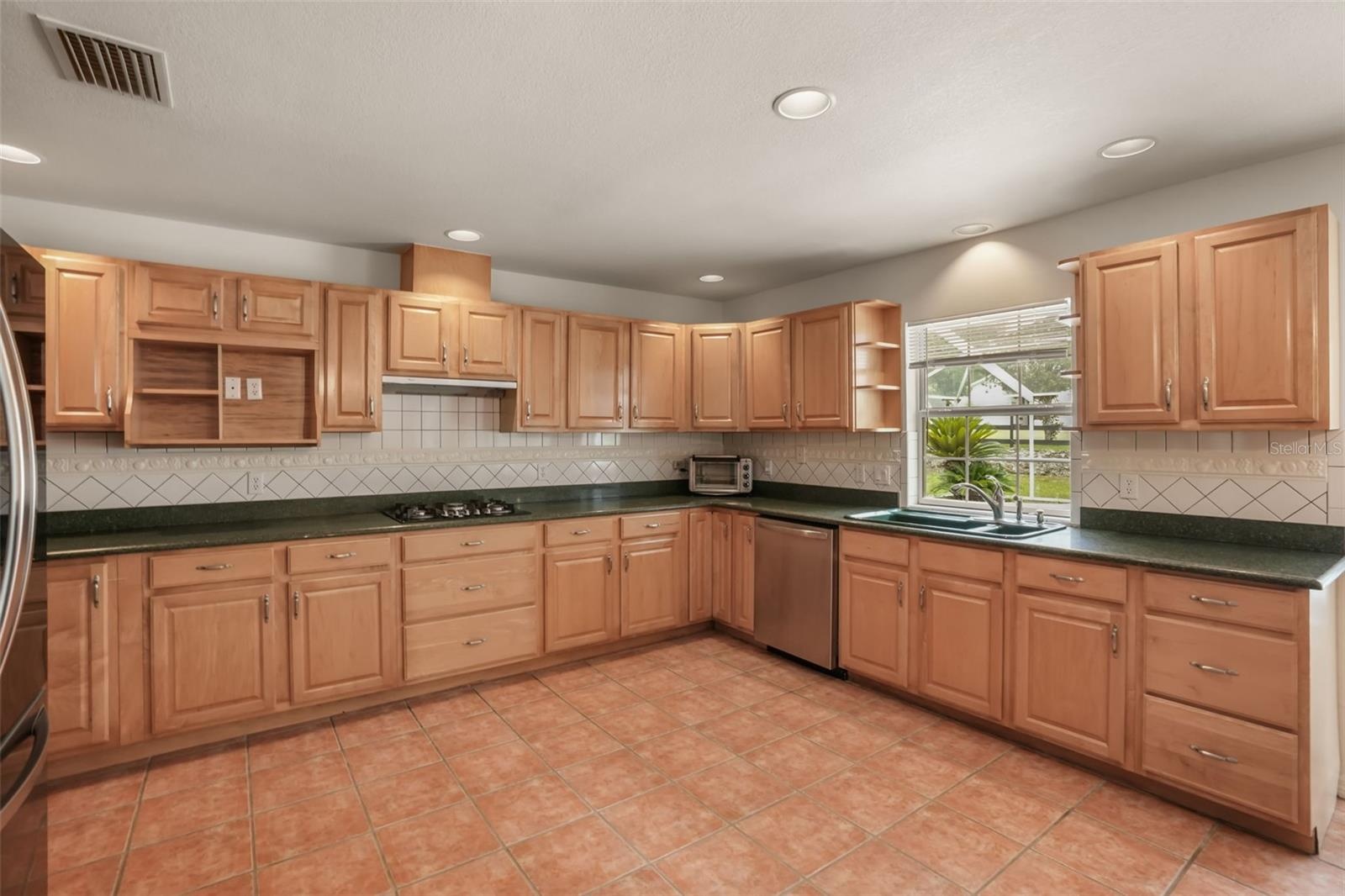 Well-appointed kitchen with new 2024 appliances and solid surface countertops