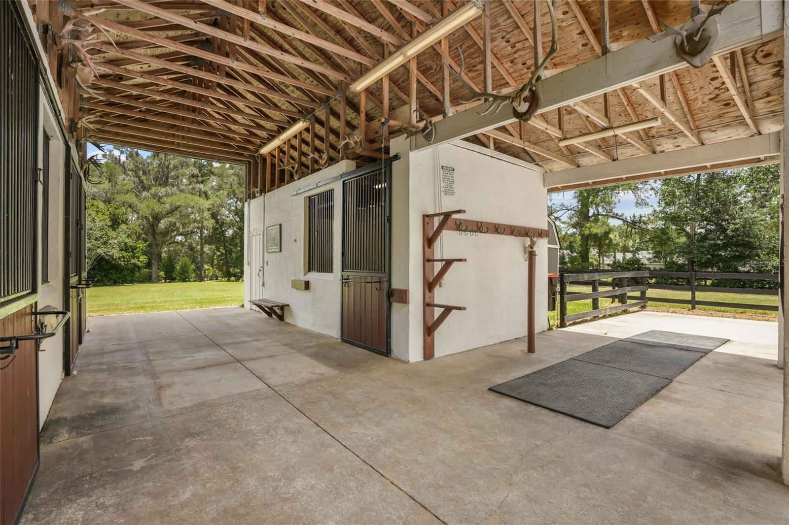 Center-aisle barn featuring matted stalls with movable walls and automatic waterers