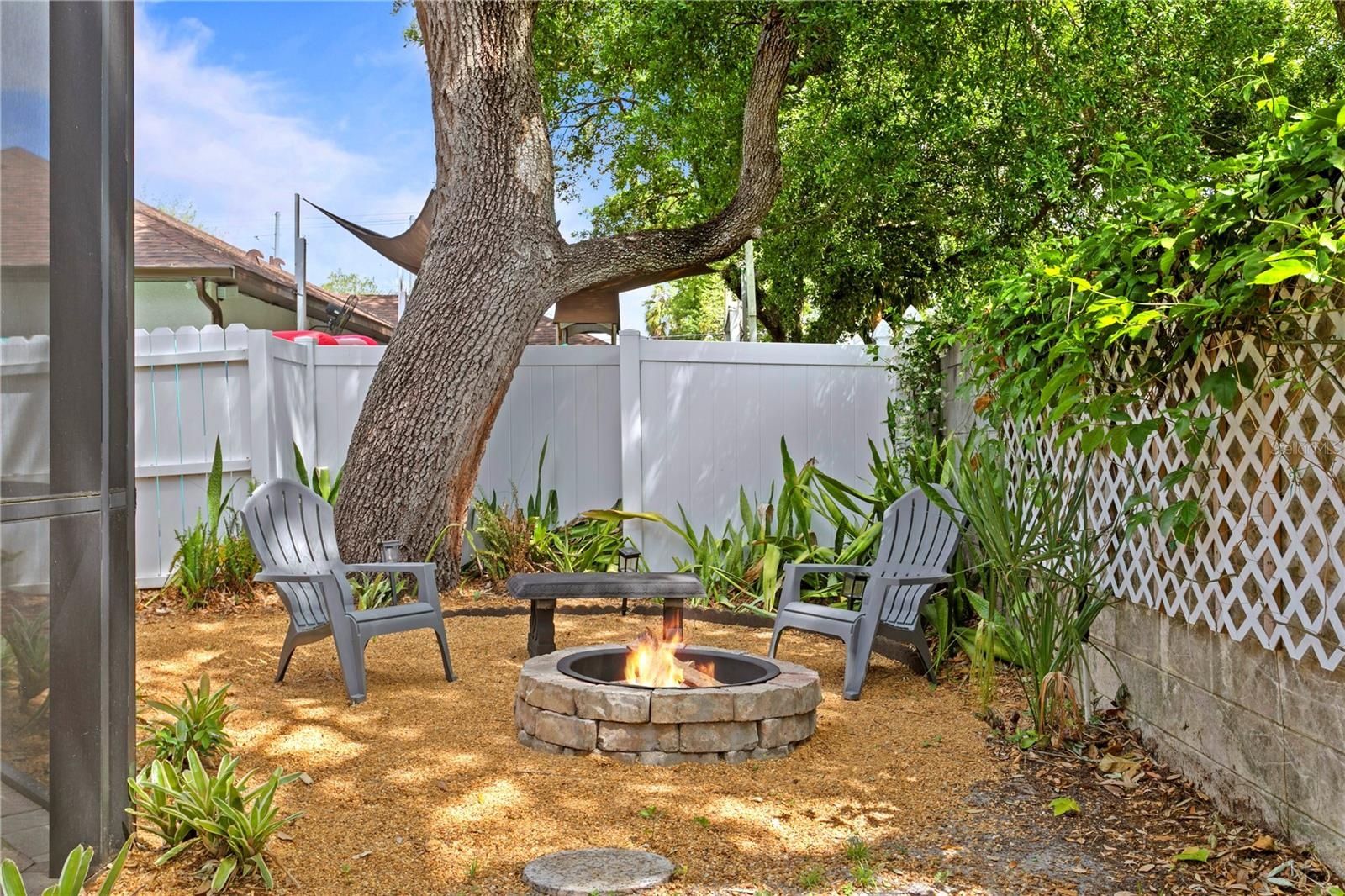Perfectly integrated into the side yard landscape, the built-in fire pit offers a cozy focal point for family gatherings, s'mores nights, and unwindin