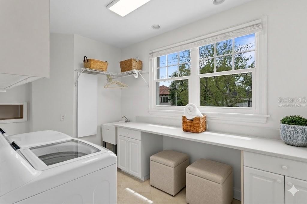 The large, sun-drenched laundry/storage room makes daily tasks a breeze (virtually staged)