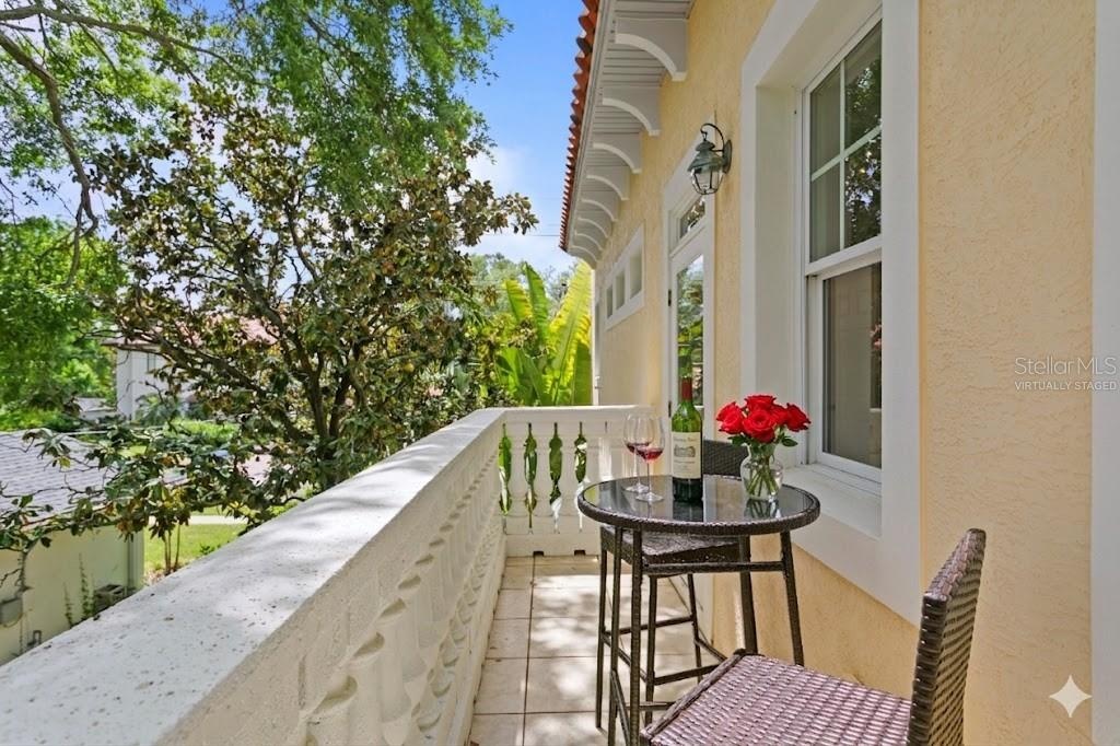 The primary retreat serves as a private sanctuary, featuring a charming Juliet balcony (virtually staged)