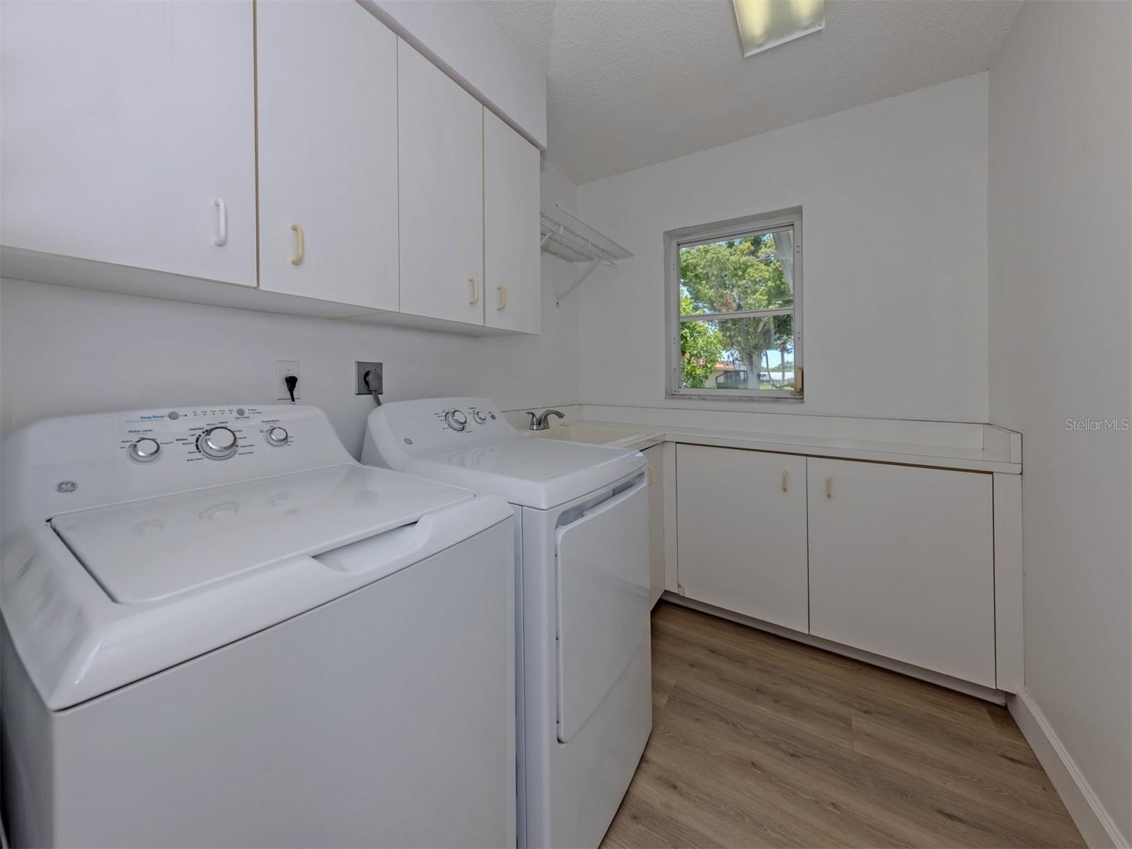 The laundry room is large and offers plenty of extra storage