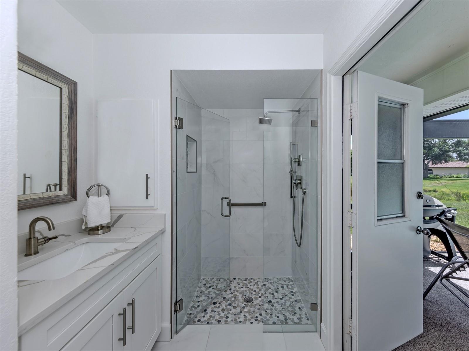 The second full bath doubles as a pool bath and is shared by both the second and third bedrooms