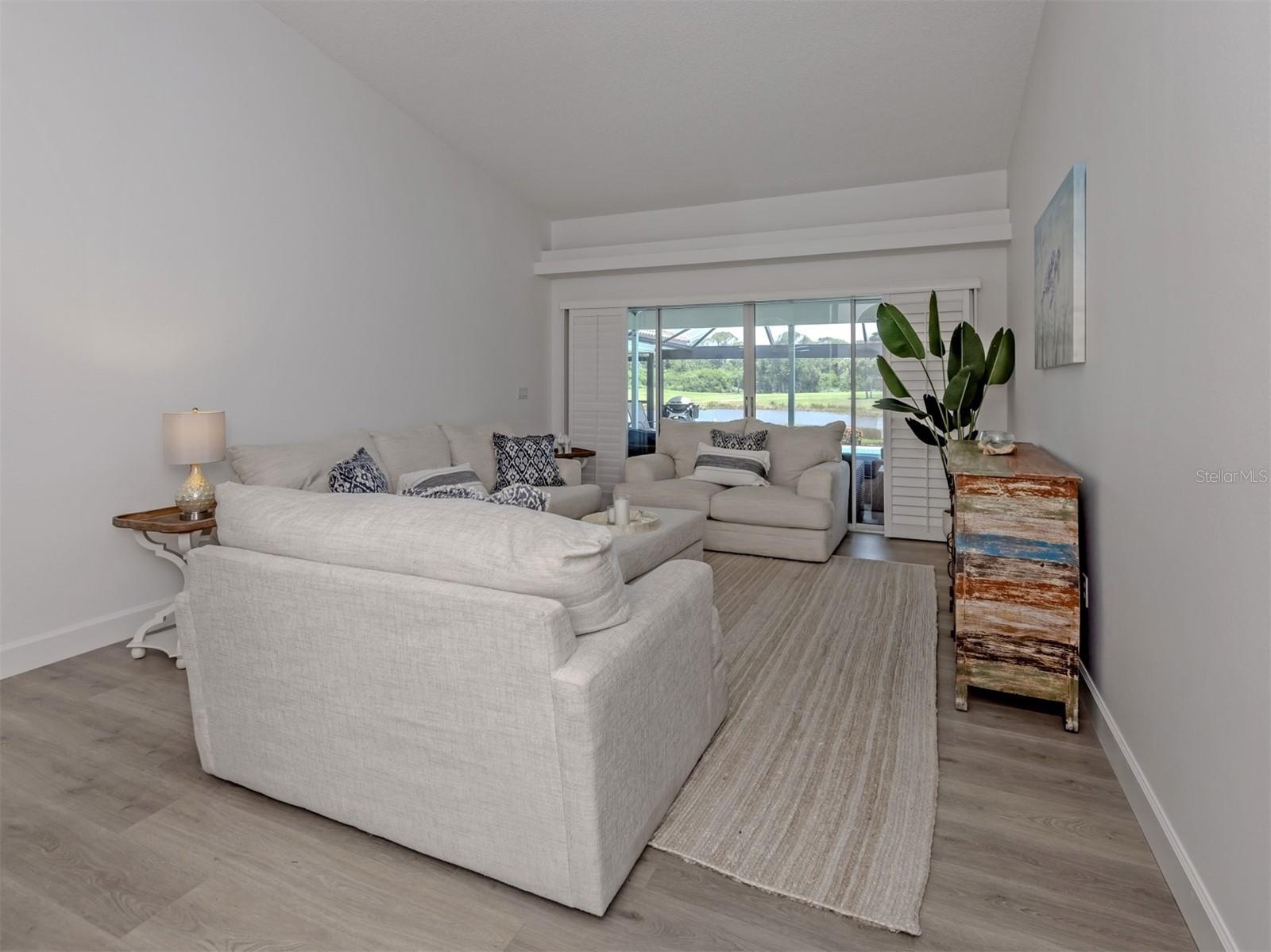 The formal living room includes sliding glass doors that open to the lanai