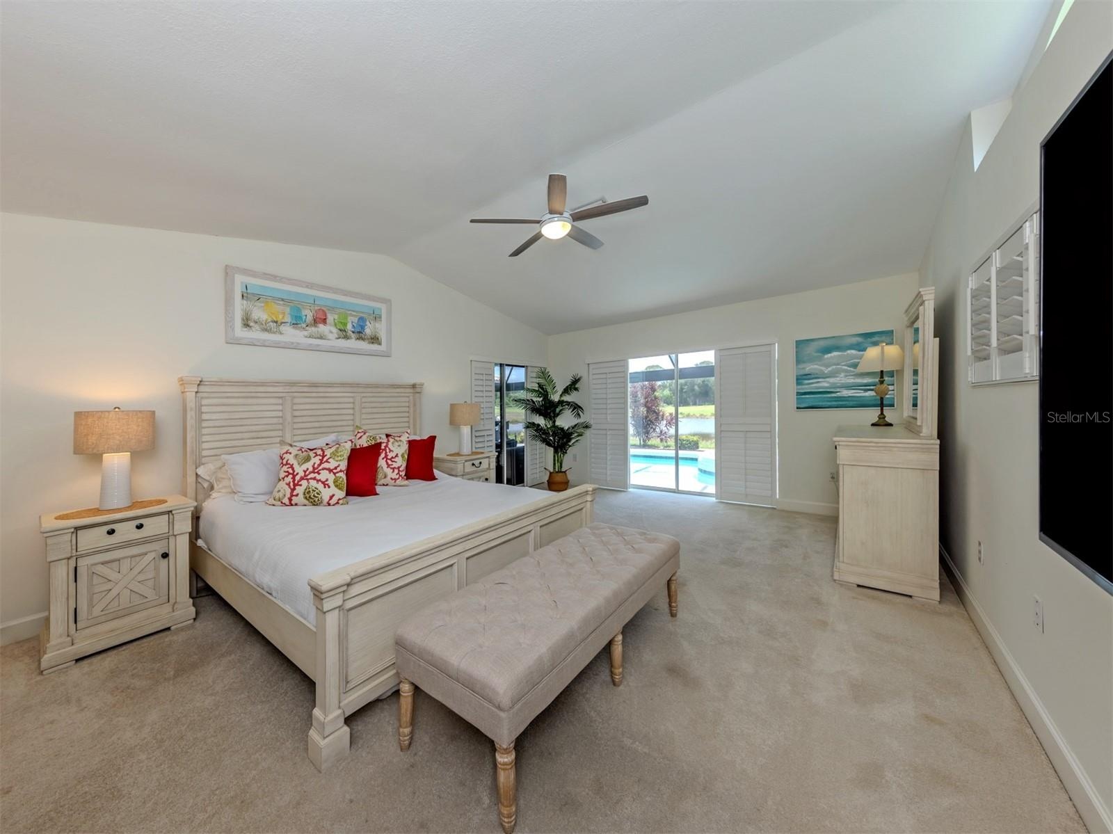 The primary suite includes two large walk in closets, private en-suite, and sliding glass door access to the lanai for late night dips