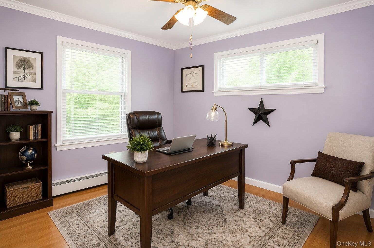 Spacious room featuring multiple windows with blinds, light wood-finish flooring, and a ceiling fan. AI Staged
