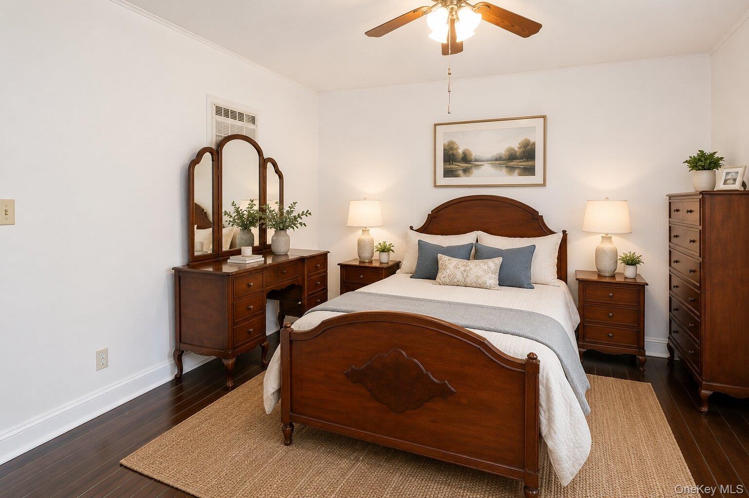 Hardwood-finish flooring, white painted walls, and crown molding