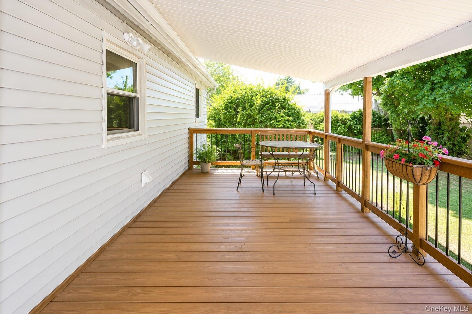 Covered outdoor deck with wood-finish flooring