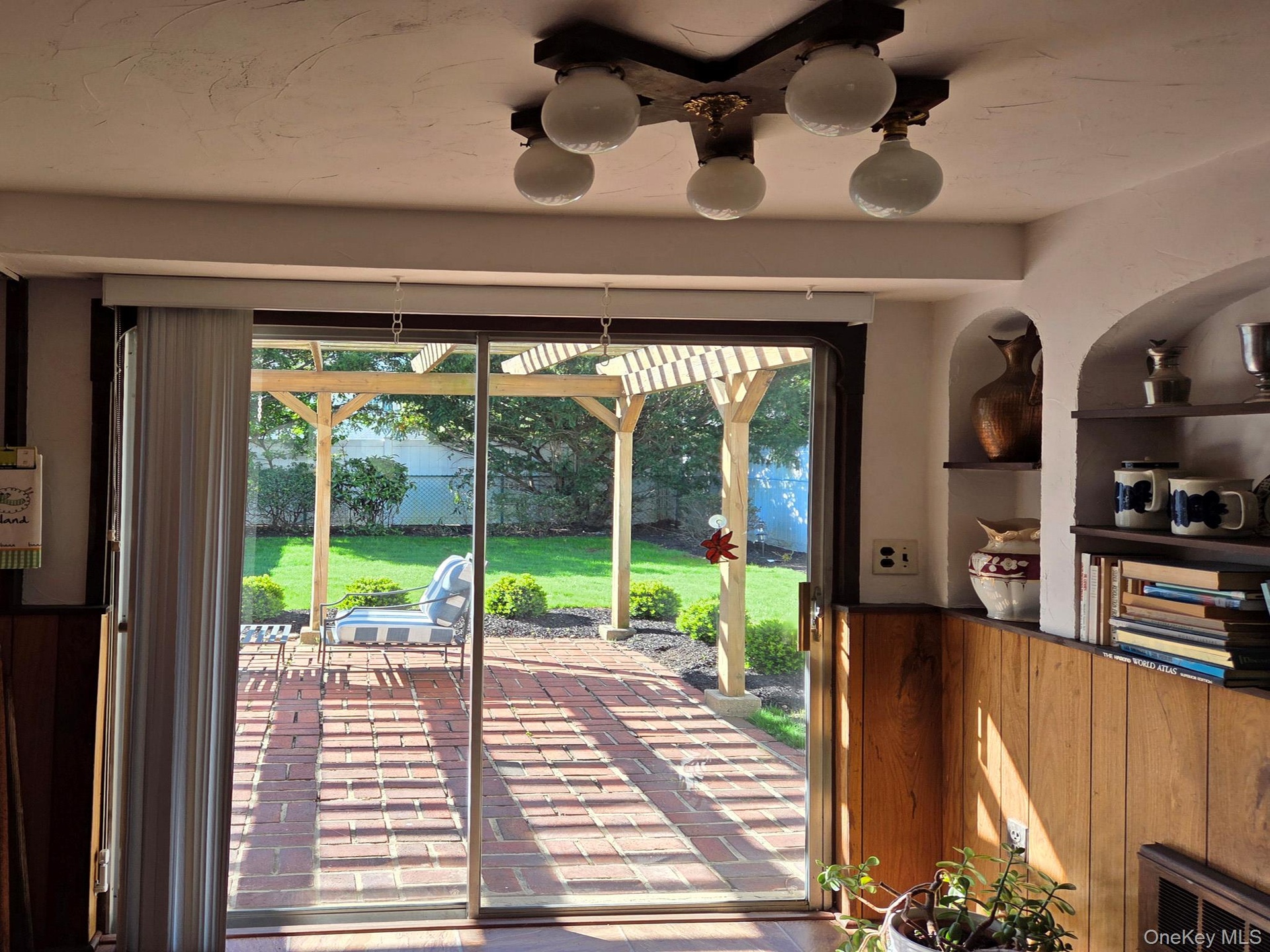 Glass sliders to the brick patio and pergola