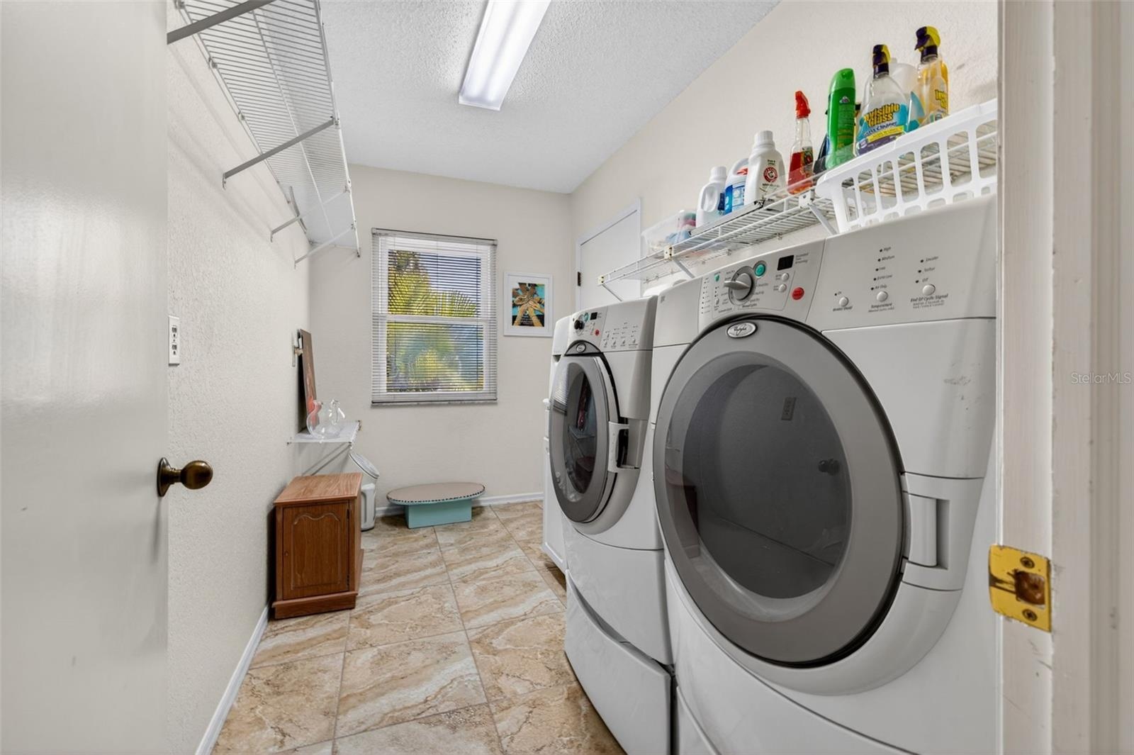 Just beyond the washer and dryer is a utility sink and access to the garage