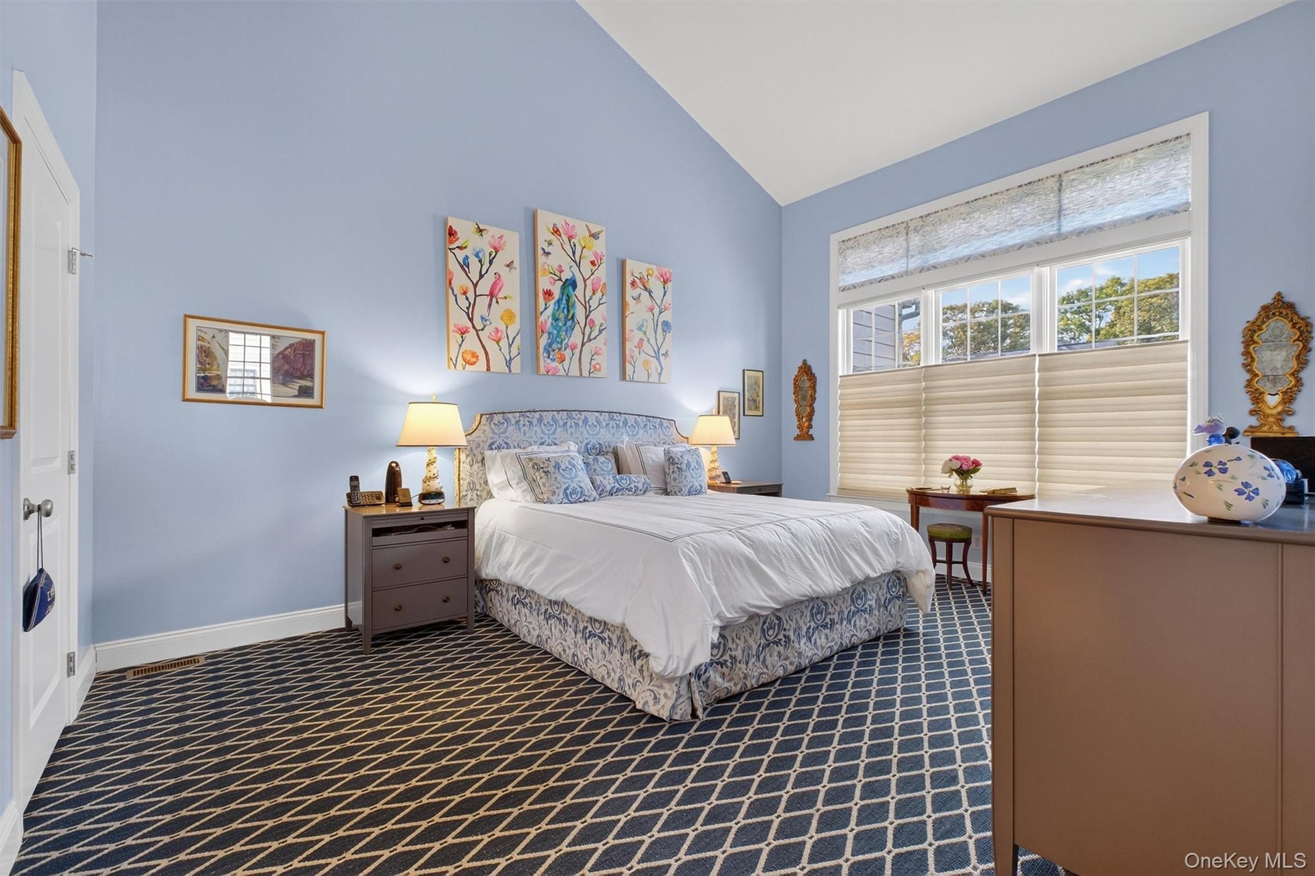 Bedroom featuring high vaulted ceiling and dark carpet