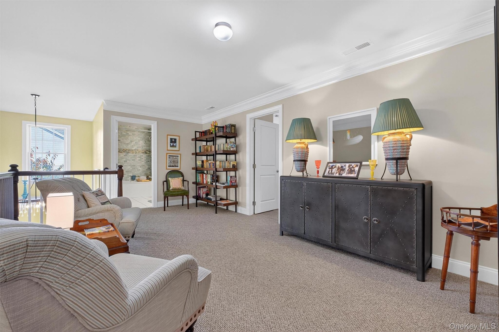 Sitting room with carpet flooring, crown molding, and an upstairs landing