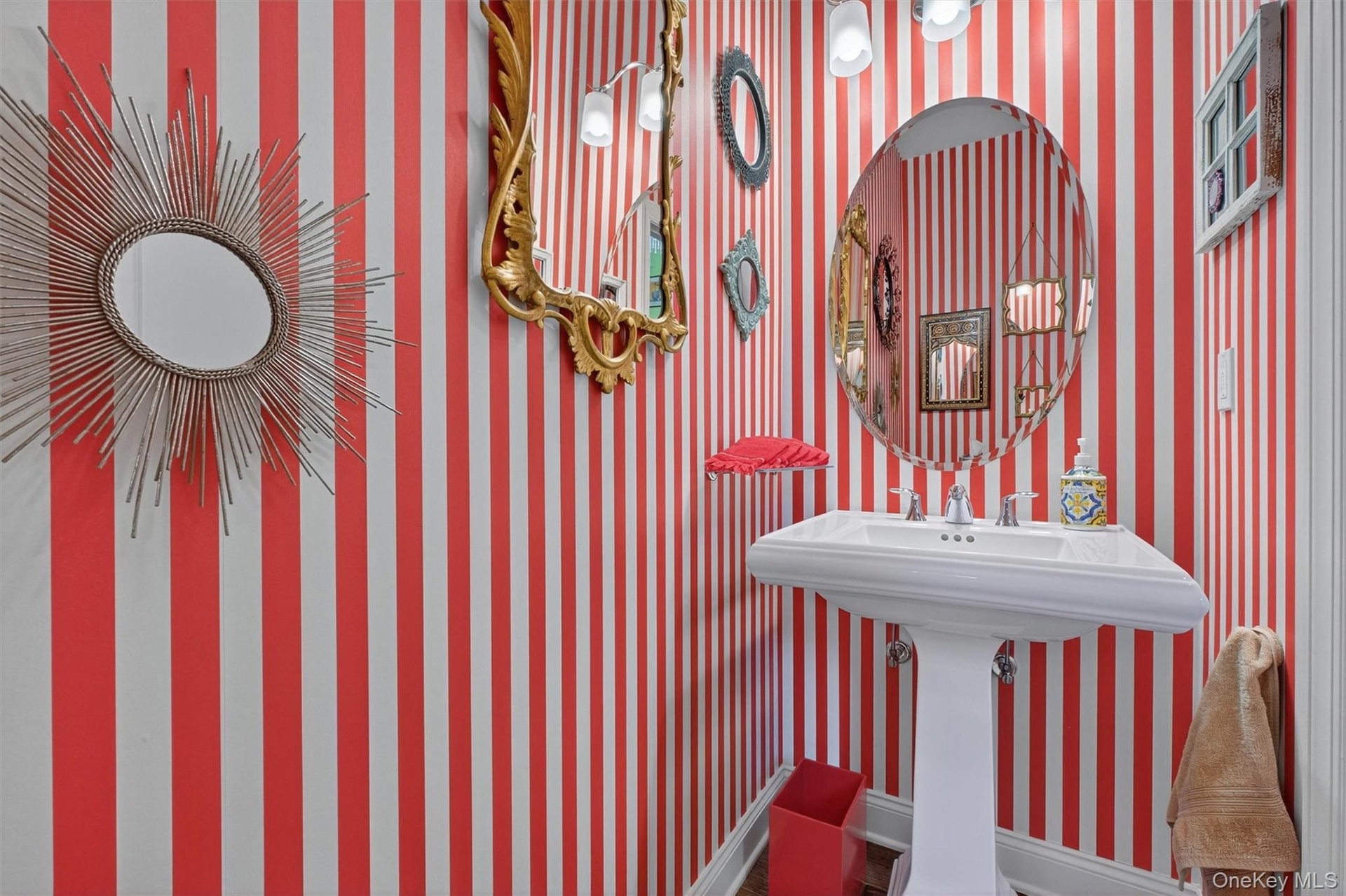 Bathroom with wallpapered walls and baseboards