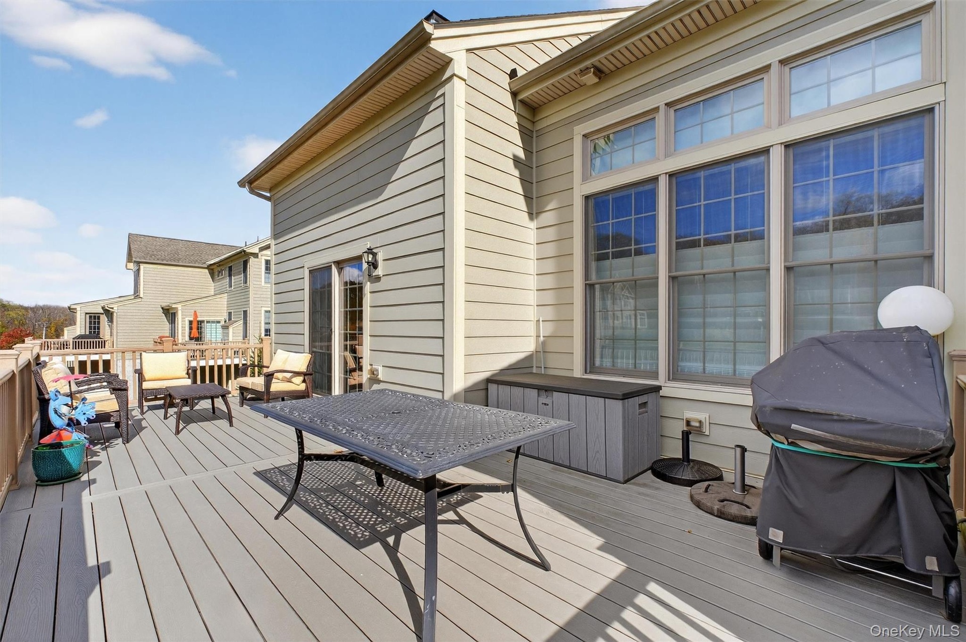 Wooden terrace featuring a grill and an outdoor living space