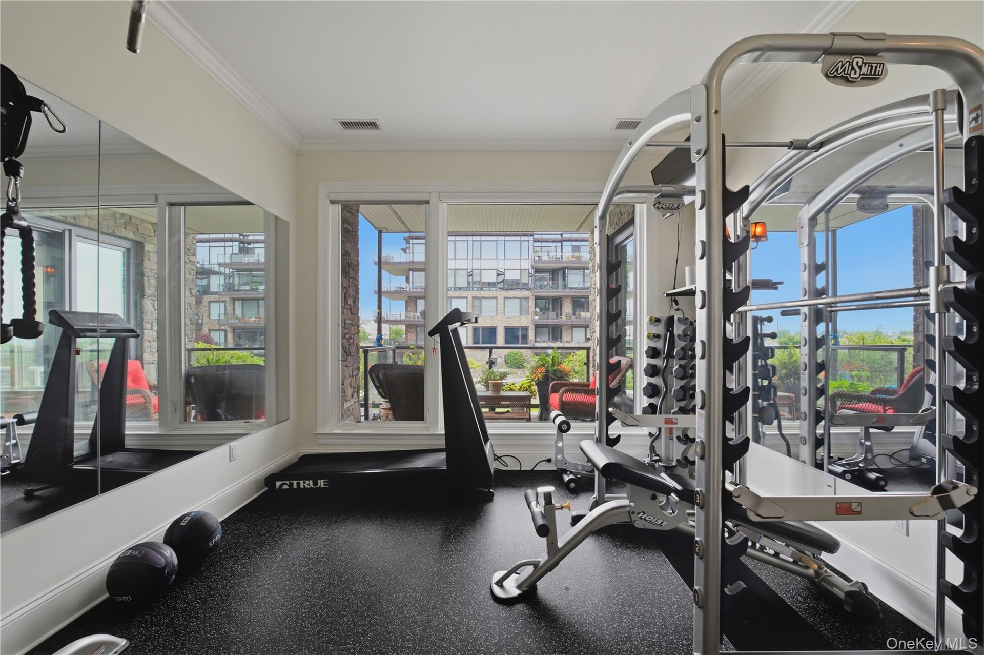 Versatile secondary bedroom currently configured as a private home gym, showcasing the flexibility of the space.