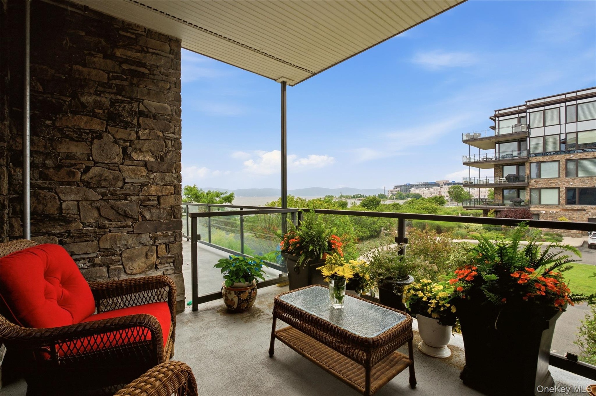 Private balcony off living room featuring beautiful river views and peaceful outdoor retreat.