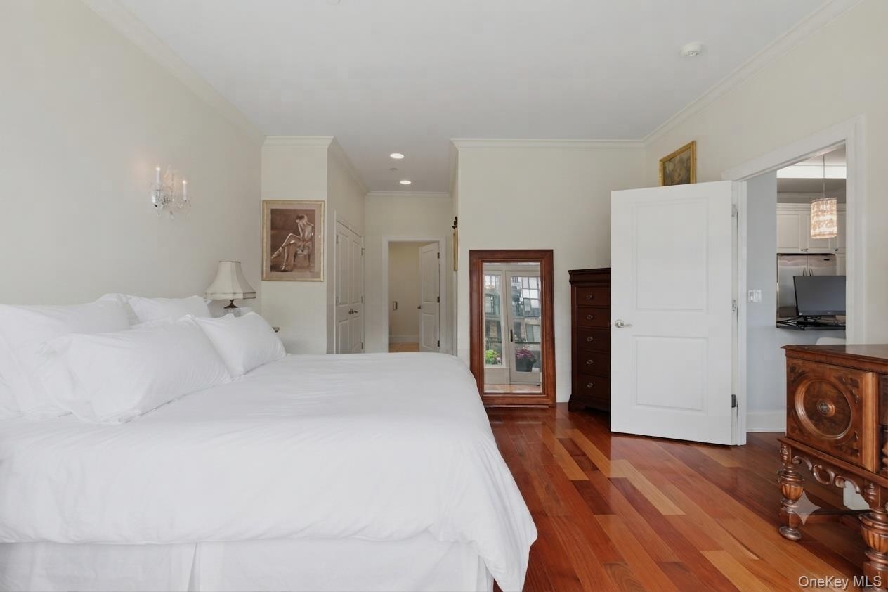 Alternate view of the primary with view of the ensuite bath. (Bedding was virtually staged)