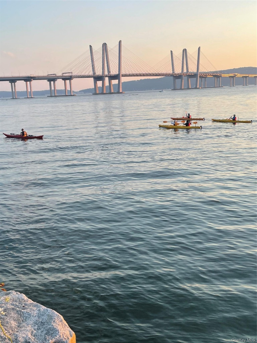 Spectacular Hudson River Views showcasing the bridge and the vibrant waterfront lifestyle, complete with kayakers on the water.