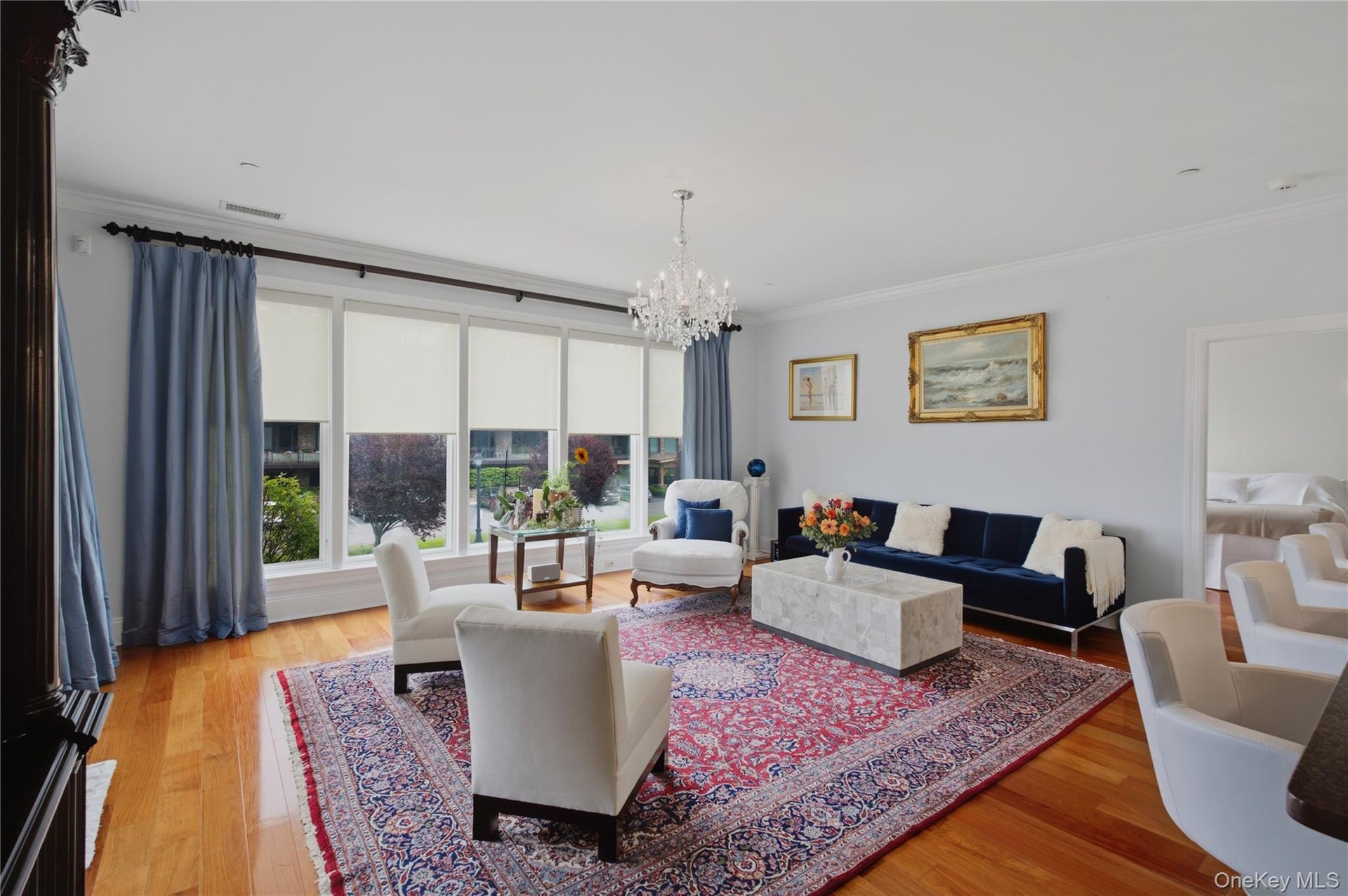 Spacious living room with beautiful large windows creating an airy, open atmosphere