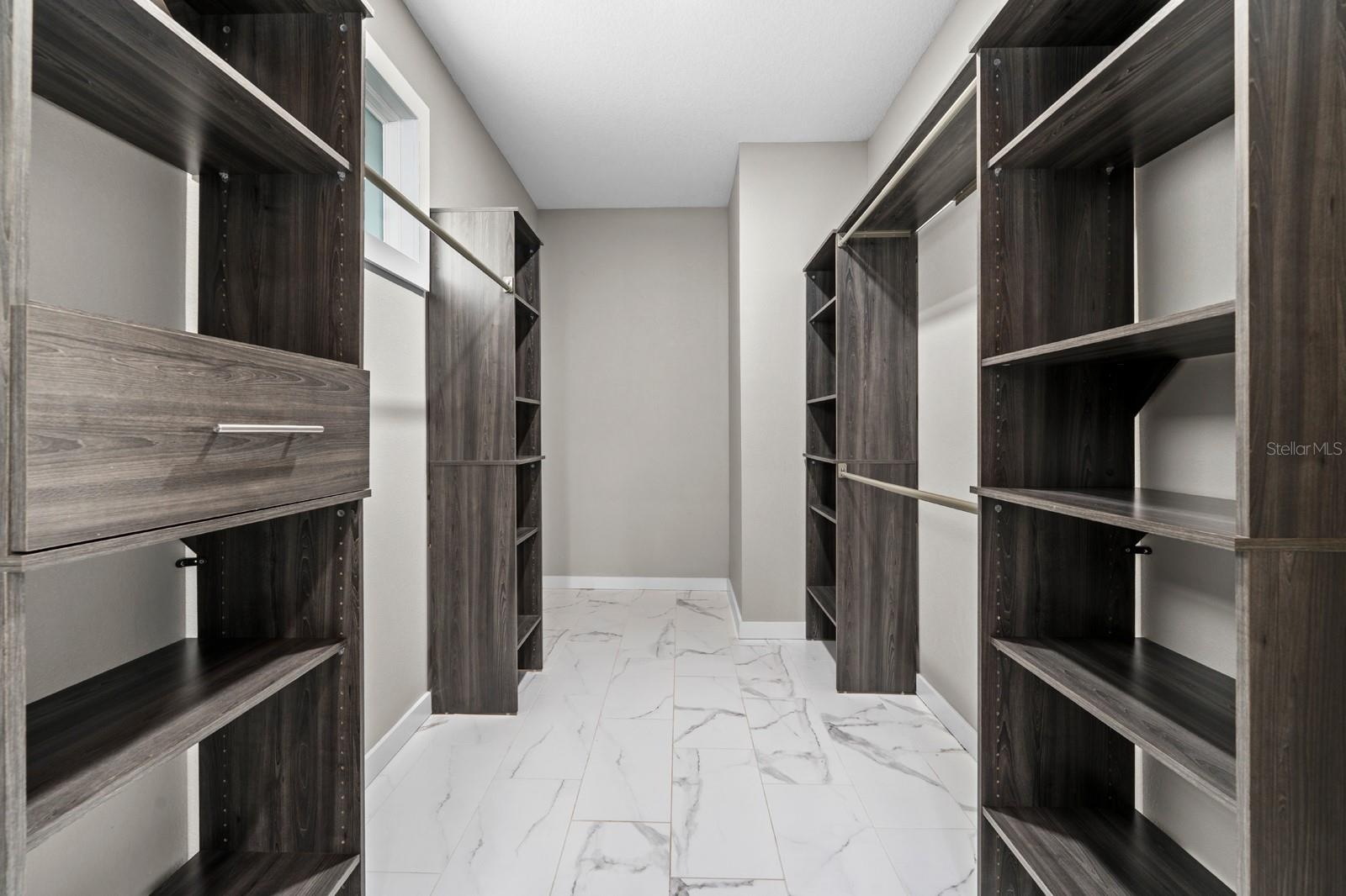 Custom walk in closet designed for exceptional storage