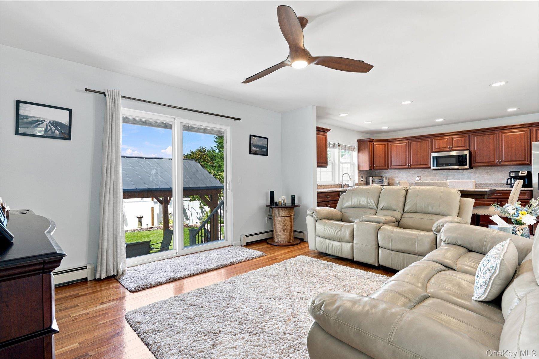 Large Den off of Kitchen with sliders to beautiful back yard,