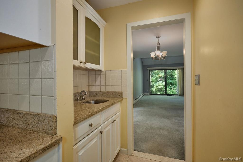 Separate area with a small sink and storage could be used as a bar area