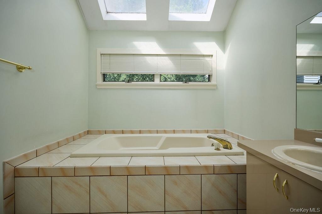 Enjoy bathing in the Jacuzzi tub with two skylights above