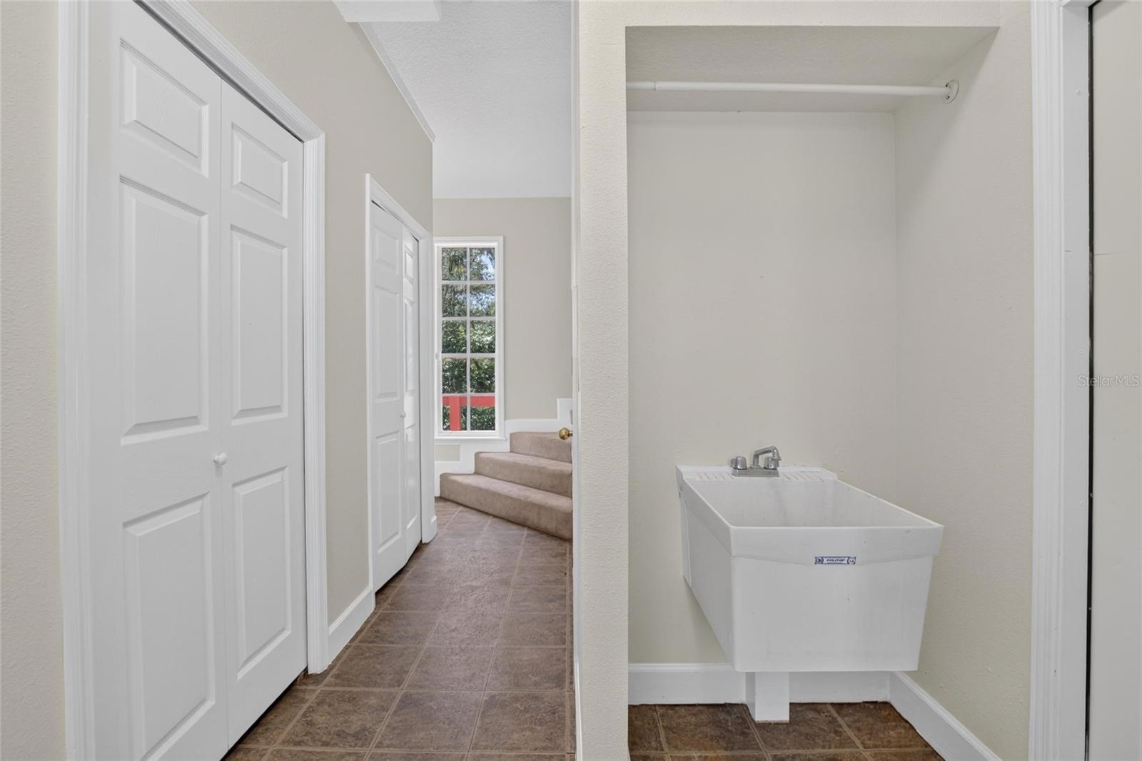 Laundry Room with Stairs to Unfinished Attic