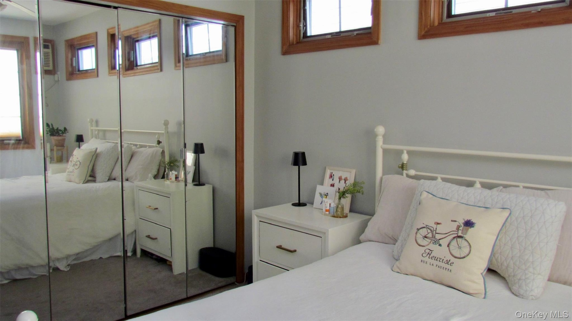 Mirrored closet doors with wood-finish framing