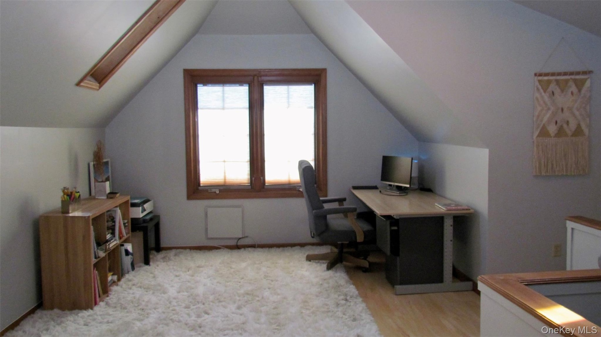 Third floor, room with sloped ceilings and light wood-finish flooring