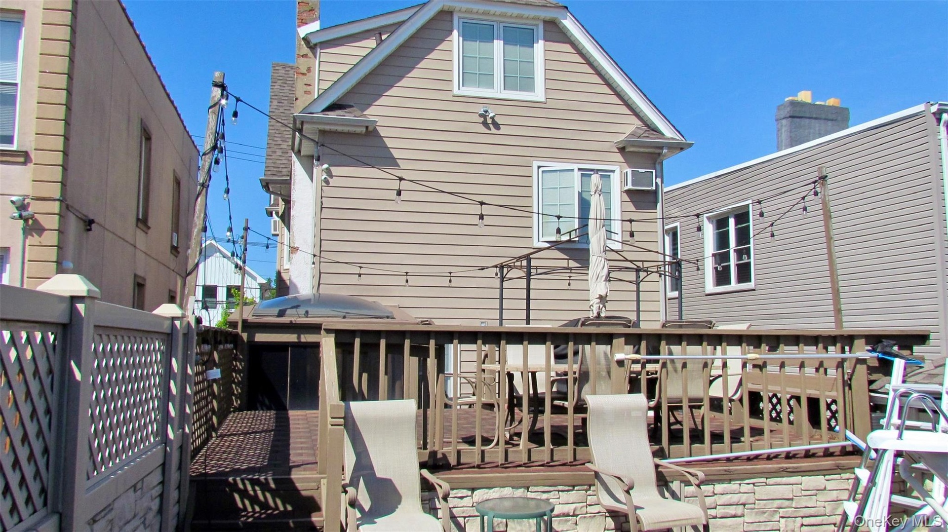 Multi-level exterior deck featuring wood railing and stone veneer accents