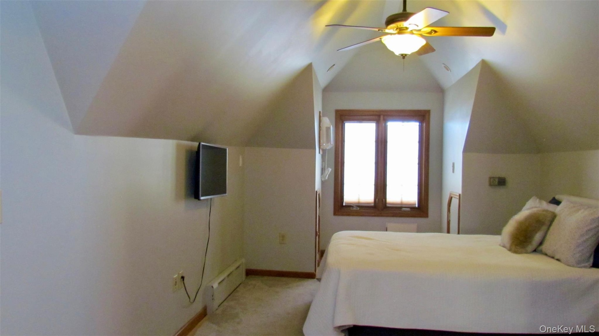 Third floor, room featuring sloped ceilings, a wood-framed window with blinds, and a ceiling fan with integrated lighting