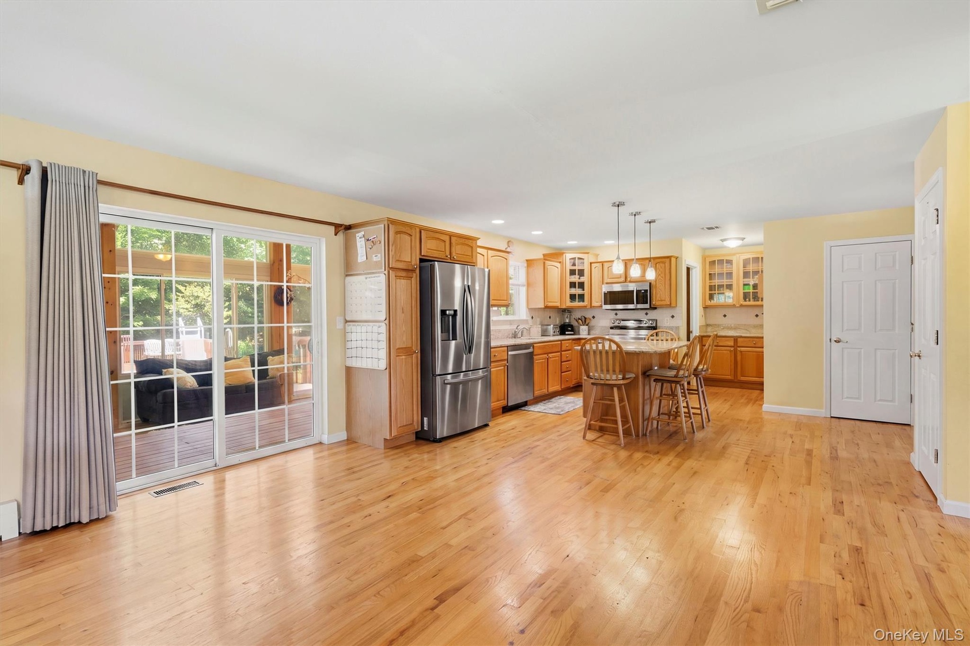 Family room/kitchen nook with view of the rear three season room.