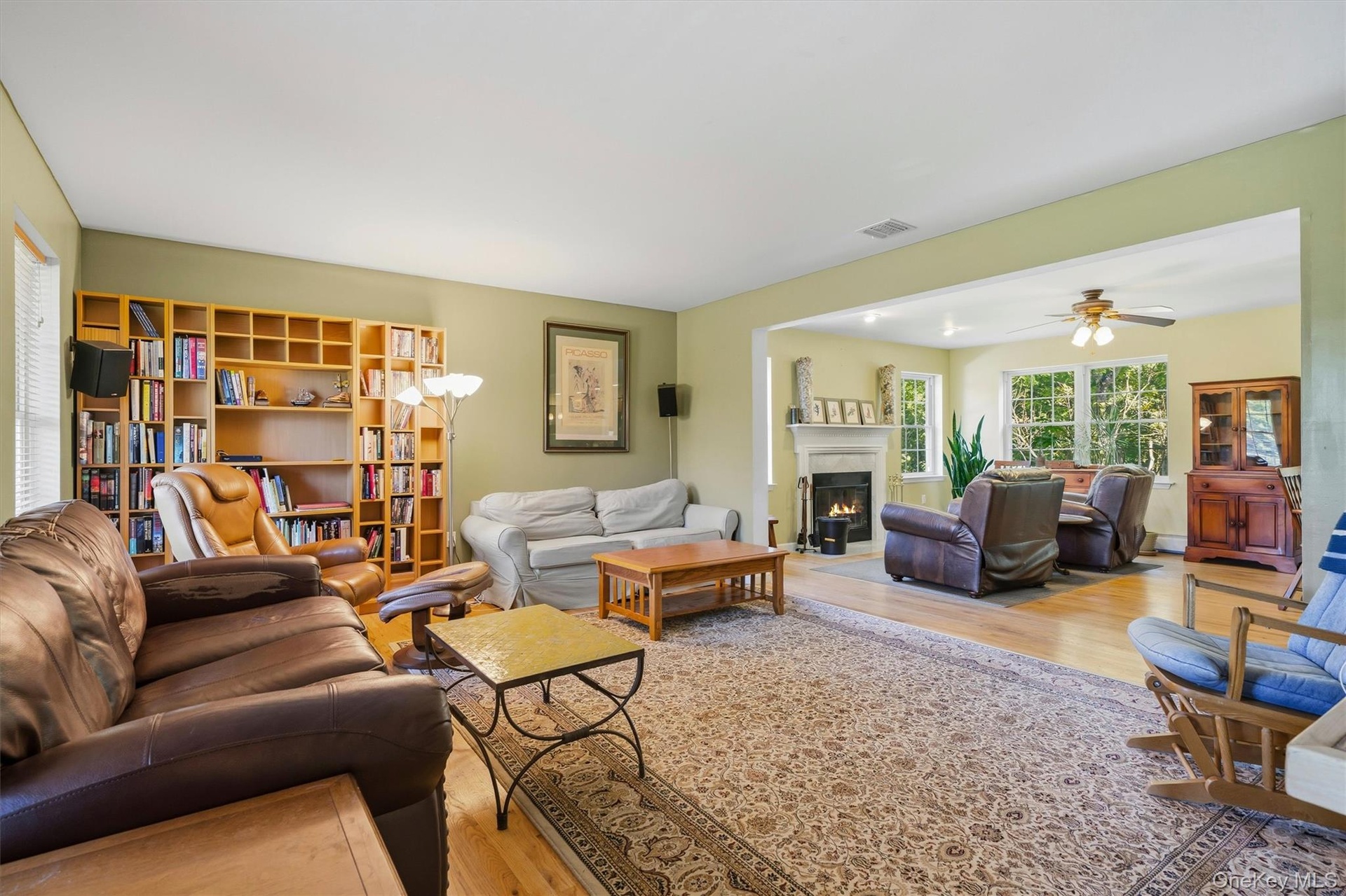 living room with view of the family room with fireplace.