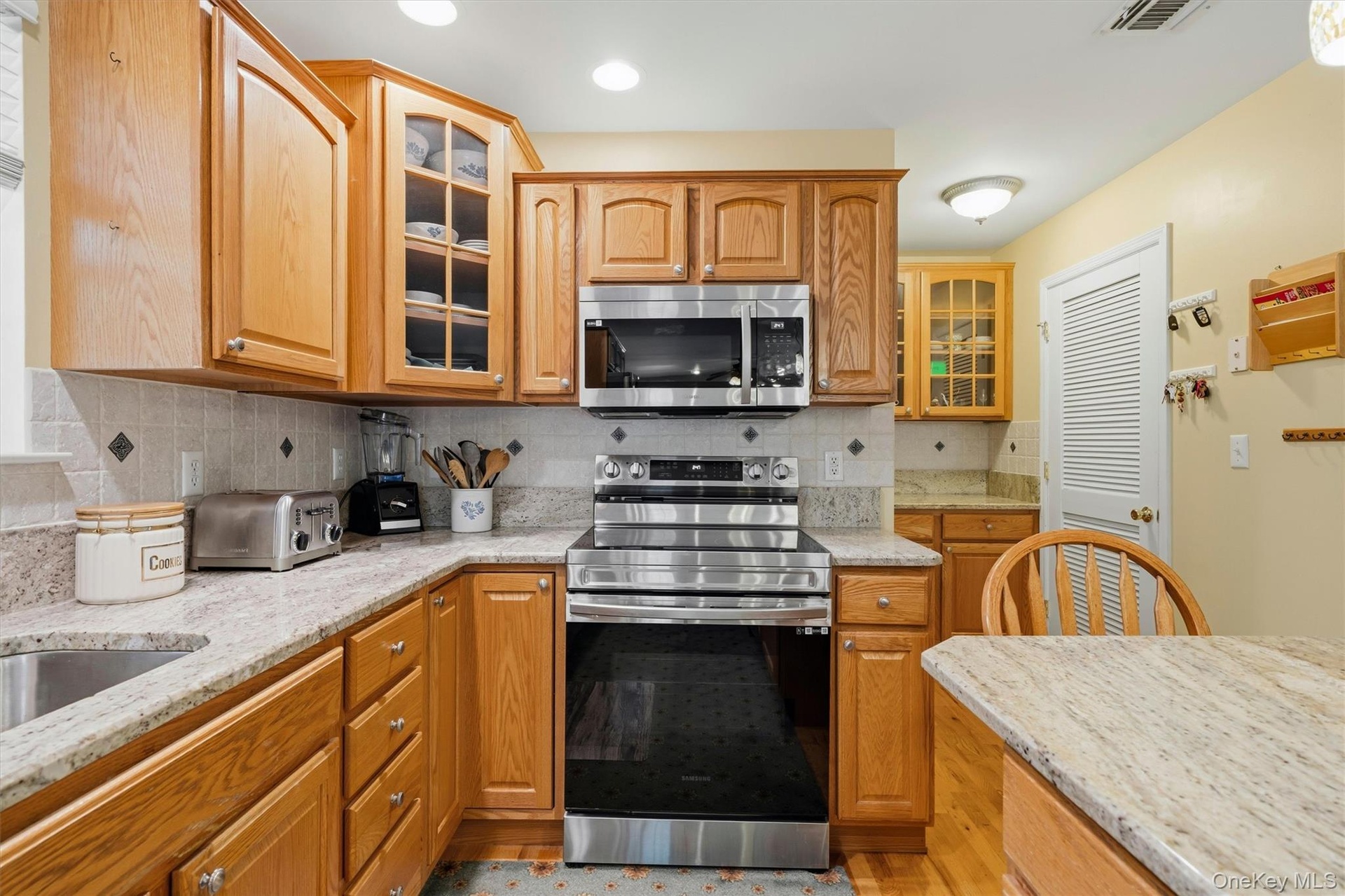 View of kitchen with hallway leading to the laundry on right.