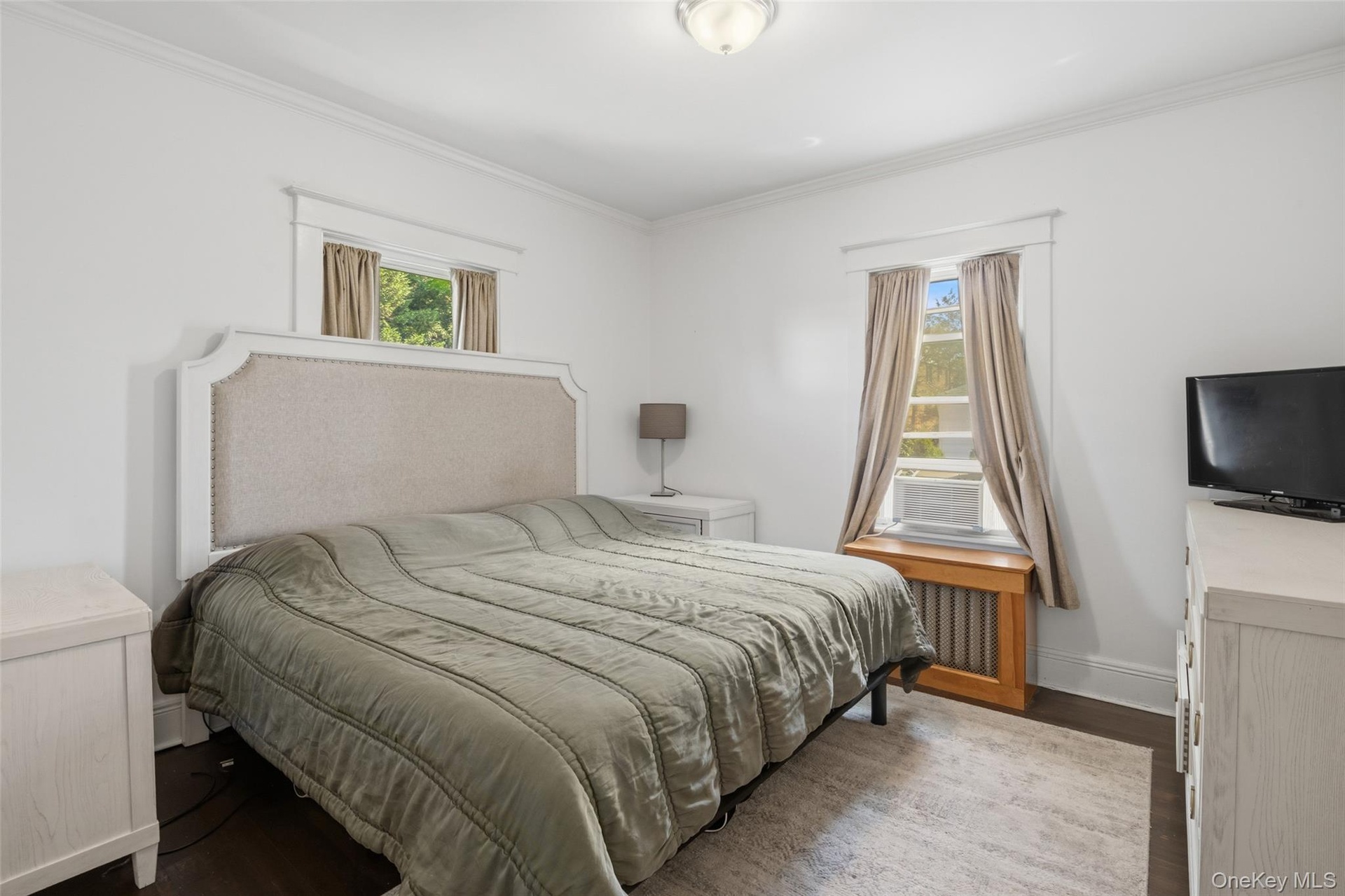 Bright primary bedroom facing the backyard (#222)