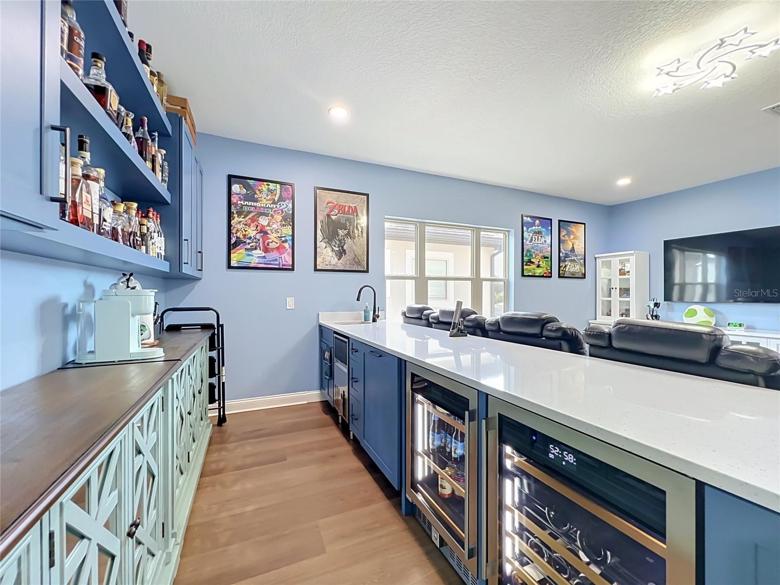 Wine coolers and ice maker complete this bar area
