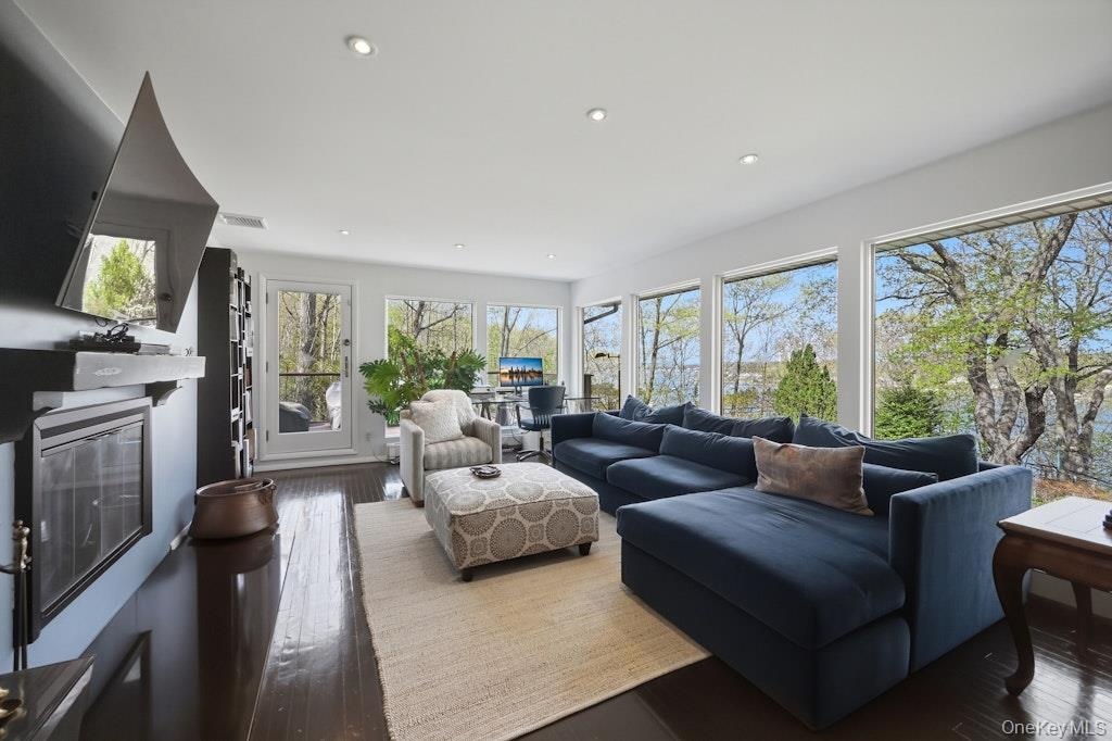 Walls of glass, door to deck, fireplace and spectacular views