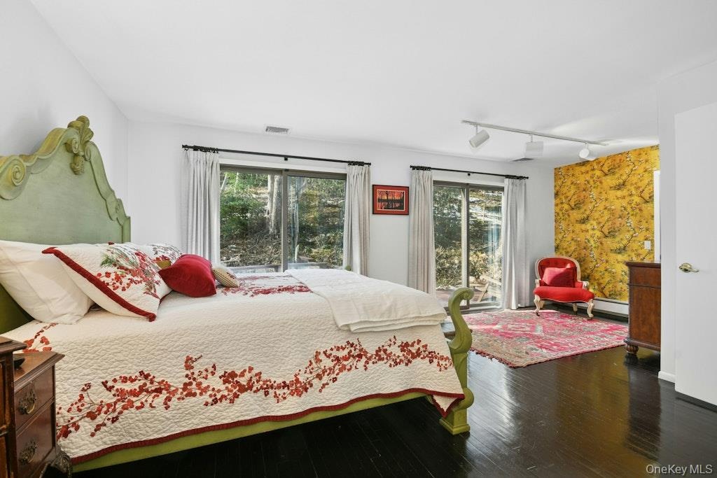 features sliding doors to private deck, walk-in closet, wood floors