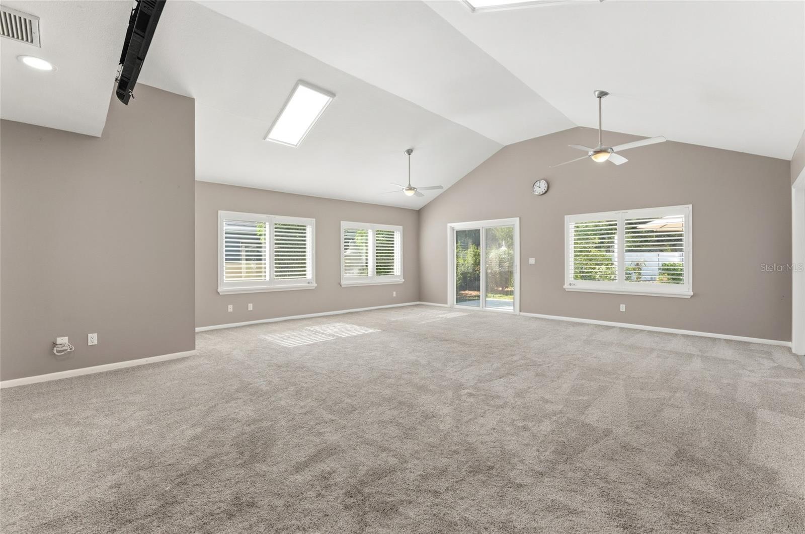 large bonus room with 1/2 bath ensuite with doors to back yard