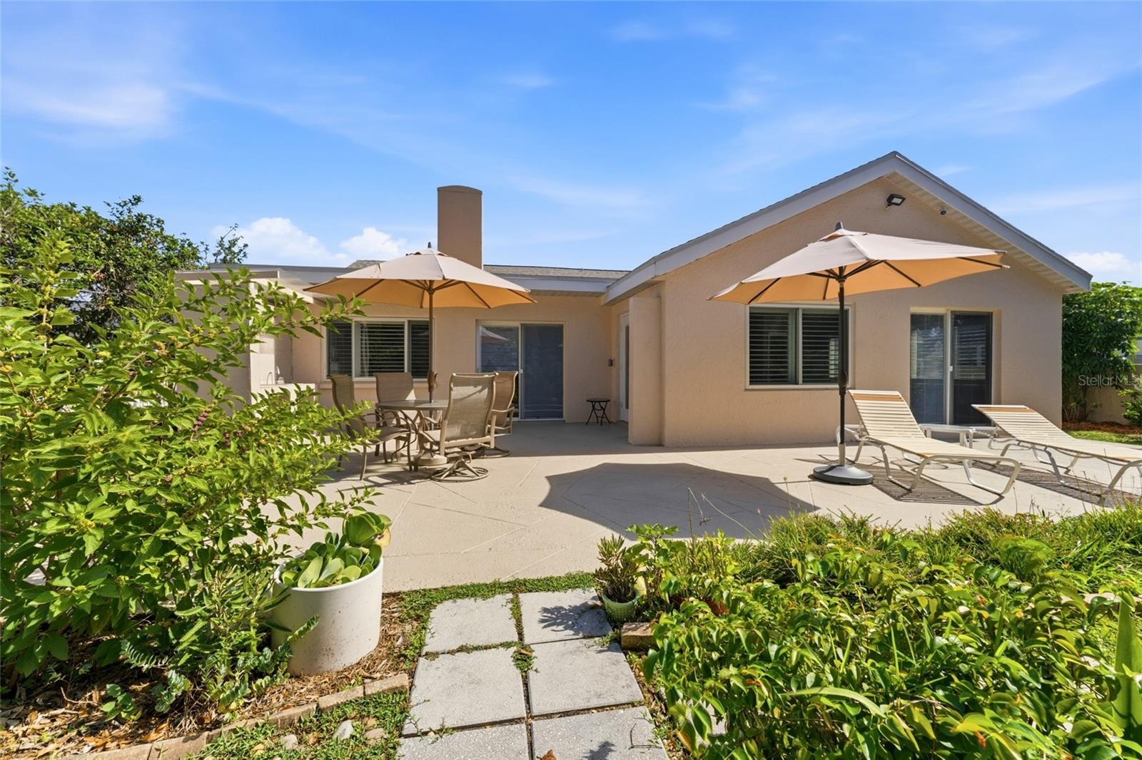 large concrete patio in back of home