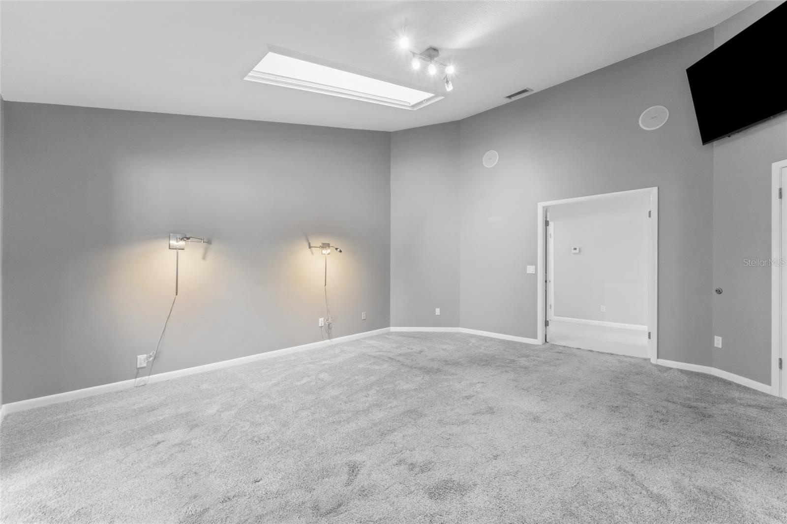large primary bedroom looking towards hallway with double doors