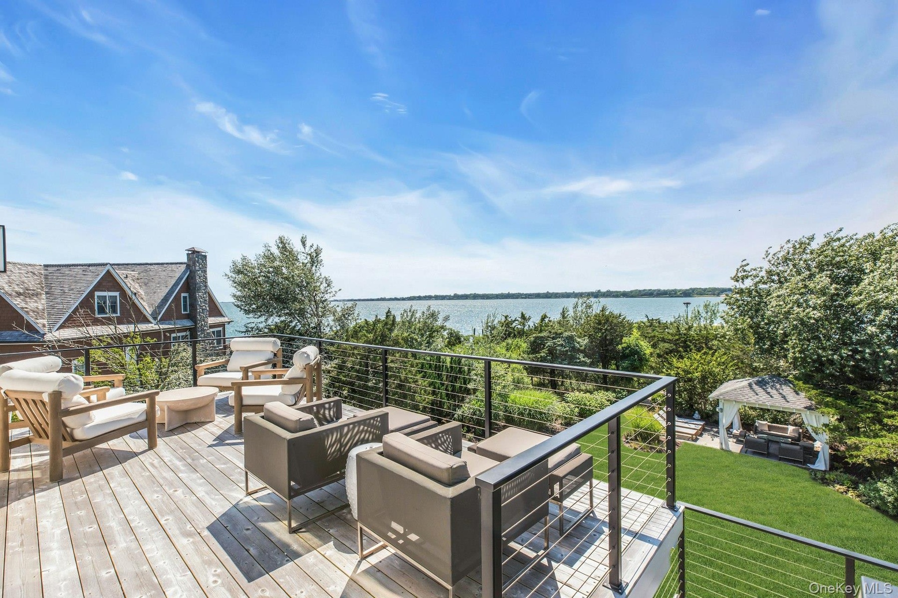 Expansive wood-finish deck with cable railing