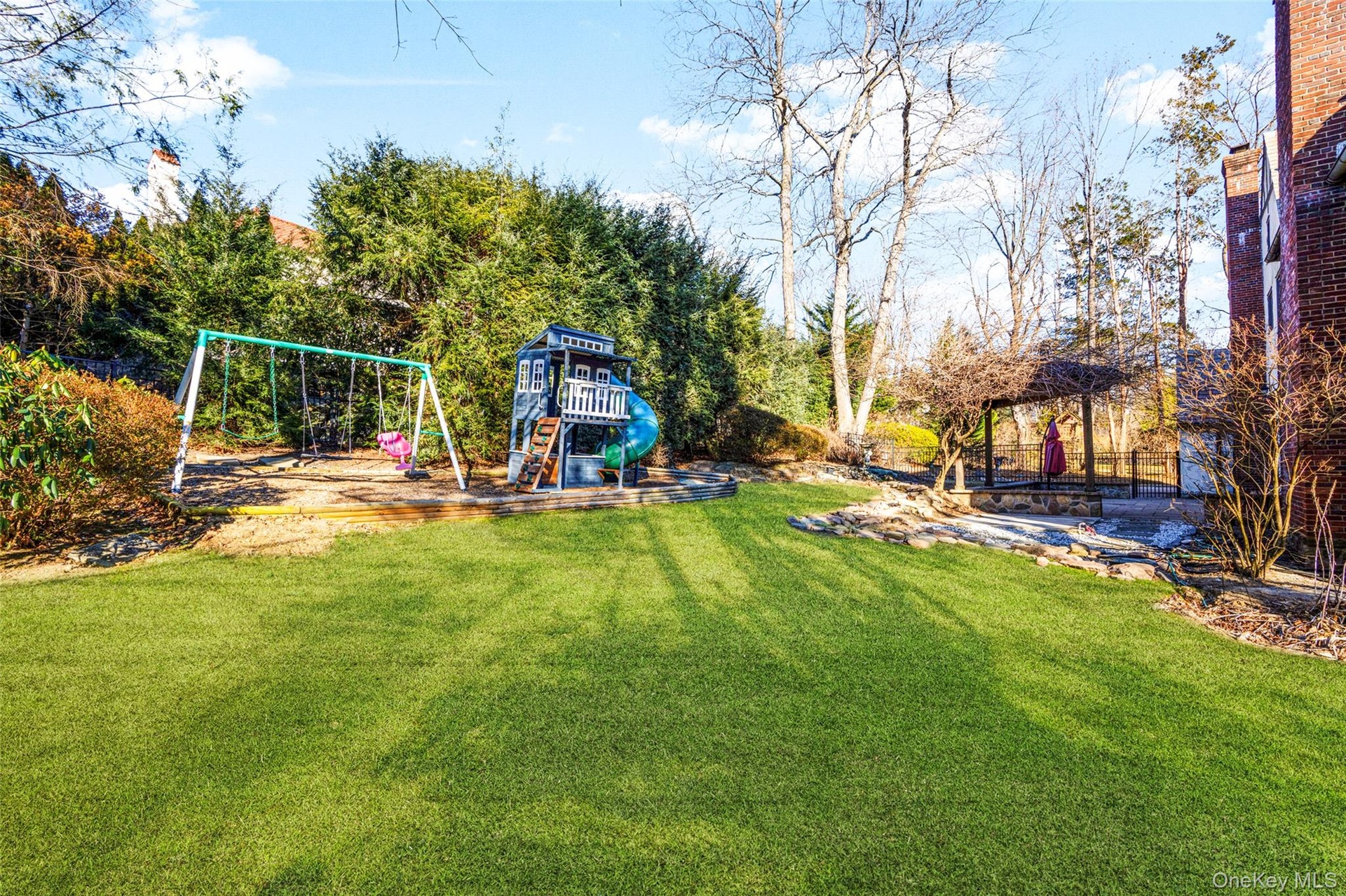 Back yard with play set and shed.