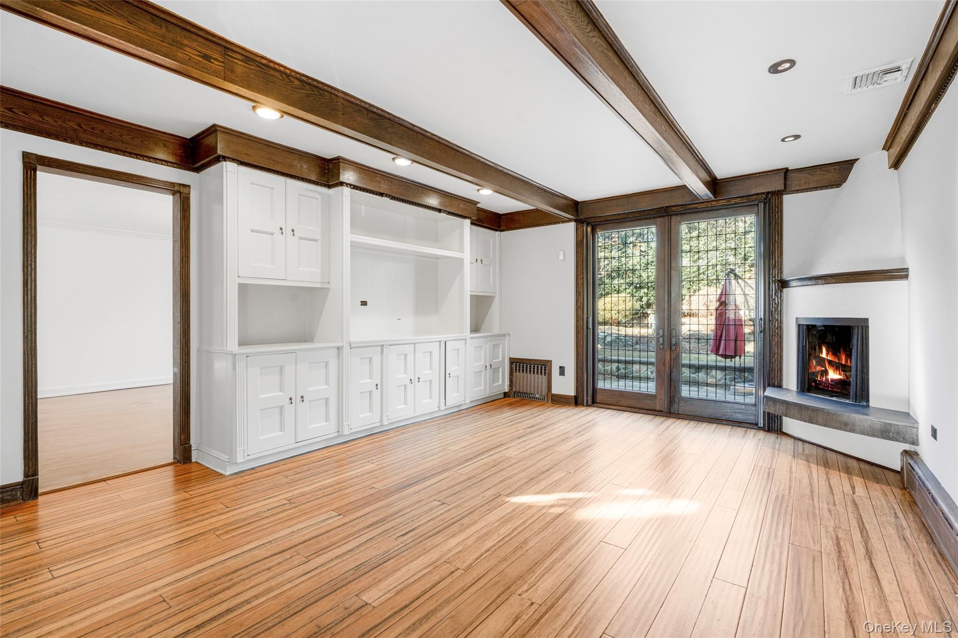 Family room with fireplace.  French doors to large patio and backyard.