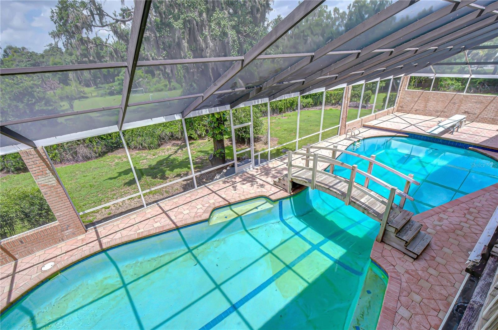 Screened swimming pool designed for recreation.
