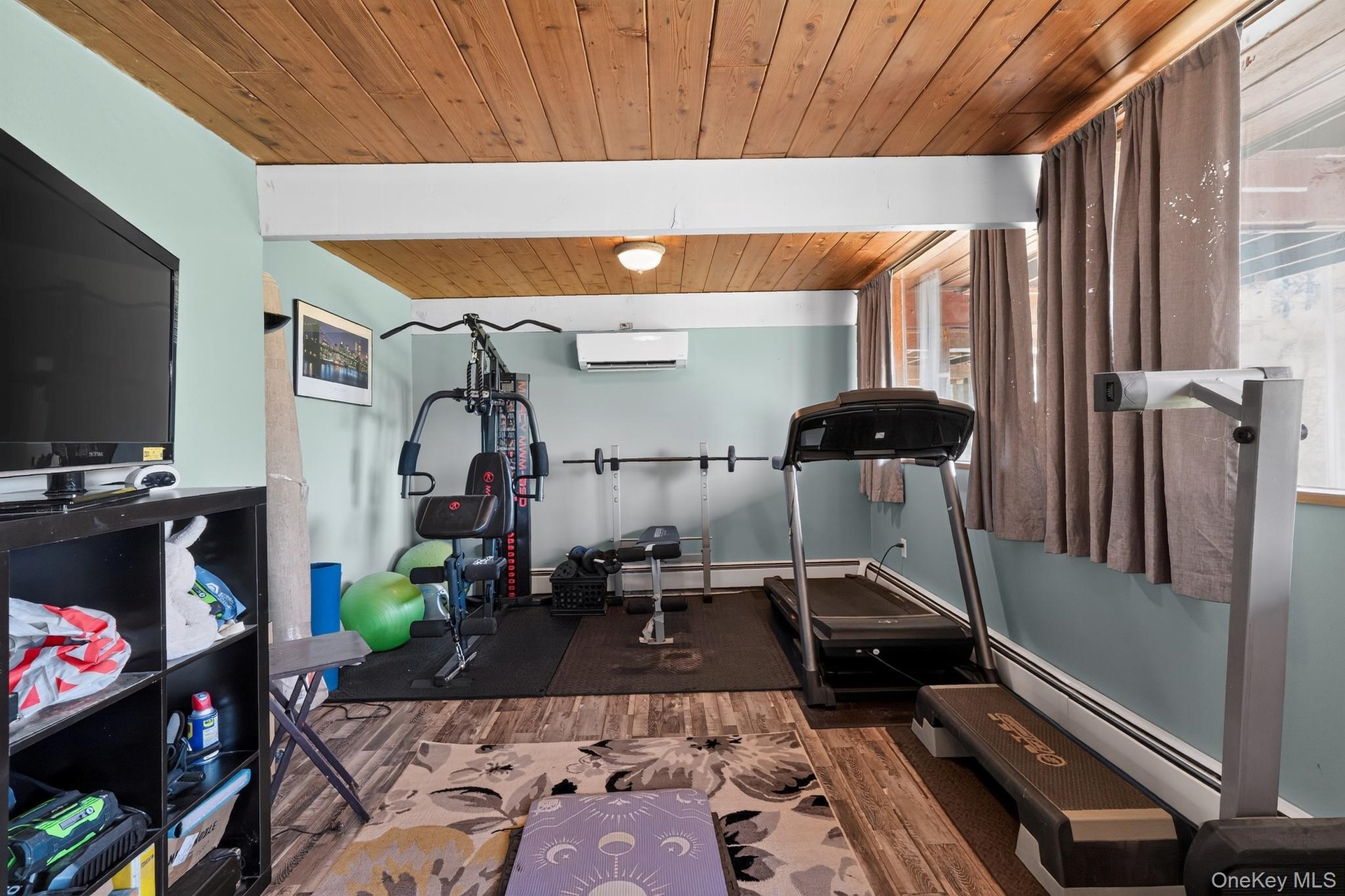 Recreation room featuring wood-finish ceiling, light blue walls, and multiple windows