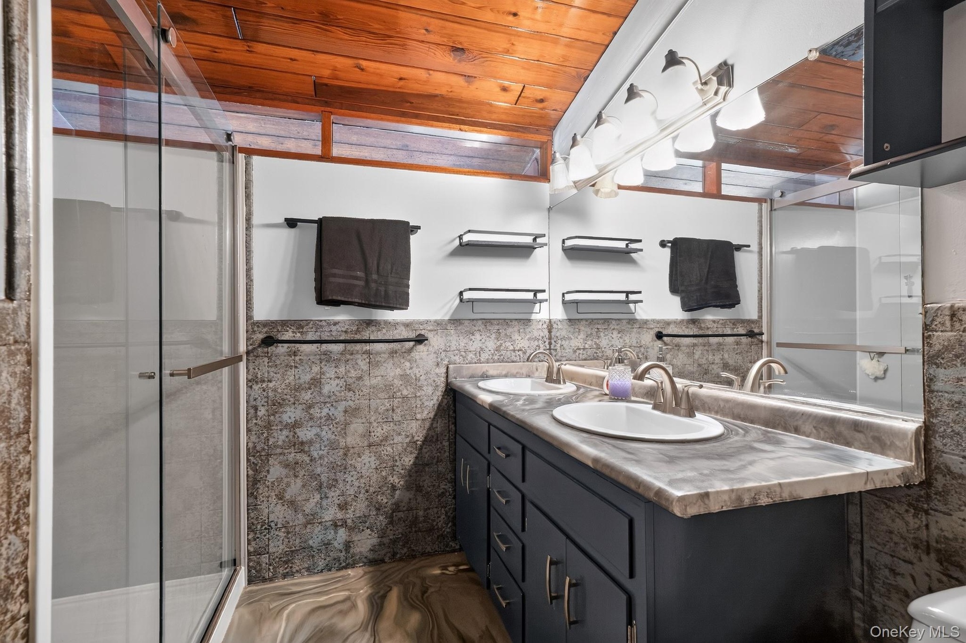 Dual vanity with under-sink cabinetry, integrated sinks, and coordinating countertop